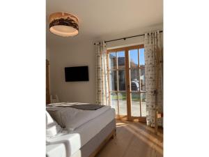 a bedroom with a bed and a large window at Ferienwohnung Max 3 in Garmisch-Partenkirchen