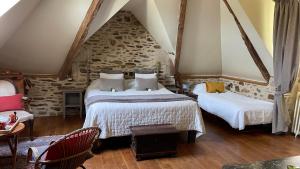 Postel nebo postele na pokoji v ubytování Le Manoir de la Bigotière
