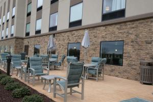 a row of chairs and tables outside of a building at Hampton Inn Searcy Arkansas in Searcy