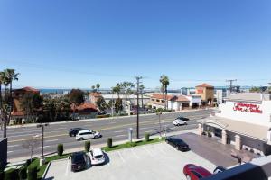 a city street with cars parked in a parking lot at Hampton Inn & Suites Hermosa Beach in Hermosa Beach