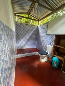 a small bathroom with a toilet in a room at Stay at the river house in Iquitos