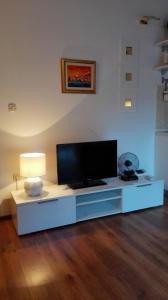uma sala de estar com uma televisão de ecrã plano sobre uma mesa em Kolombo Apartment em Jadrija