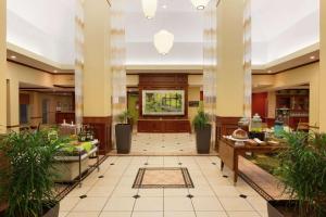 a lobby of a hotel with potted plants at Hilton Garden Inn Shreveport in Shreveport