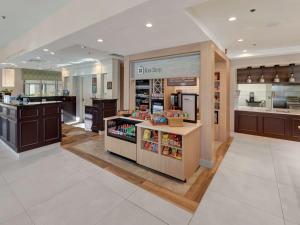 a store with a counter in the middle of a kitchen at Hilton Garden Inn Oklahoma City North Quail Springs in Oklahoma City