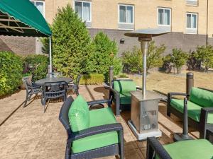 a patio with tables and chairs and a grill at Hilton Garden Inn Oklahoma City North Quail Springs in Oklahoma City