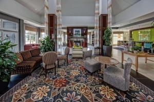 a lobby with a couch and chairs and a fireplace at Hilton Garden Inn Midtown Tulsa in Tulsa