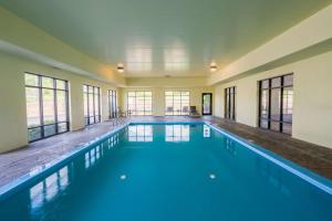a large indoor swimming pool with blue water at Hampton Inn London-North, Ky in London