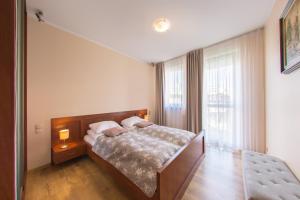 Posteľ alebo postele v izbe v ubytovaní Apartamenty Diva Kołobrzeg