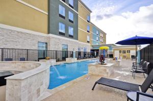 a swimming pool in front of a building at Homewood Suites by Hilton New Braunfels in New Braunfels