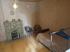 a bedroom with a bed and a stone fireplace at Central Mestia in Mestia