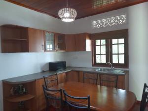 a kitchen with a wooden table and a sink at Colombo Home Stay - Horahena in Kaduwela