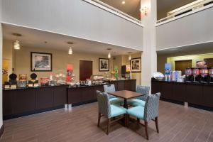 a waiting room with a table and chairs and a store at Hampton Inn Cornelia in Cornelia