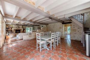 a large living room with a table and chairs at Le Moulin de Bafave in Périssac +17 photos