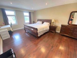 a bedroom with a bed and a dresser and a mirror at Lovely house in a nice community in Toronto