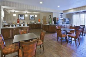 a restaurant with tables and chairs and a kitchen at Hampton Inn Pittsburgh Area-Beaver Valley-Center Township in Monaca