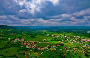 an aerial view of a small village in a green field at Kuća Marić Mačkat in Mačkat