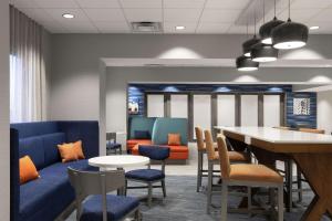 a waiting room with a table and chairs at Hampton Inn O'Fallon, Il in O'Fallon