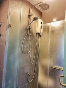 a shower in a bathroom with a glass door at Hill Myna Condo by Bcare - Two Bedrooms in Ban Thalat Choeng Thale