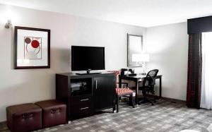 a hotel room with a television and a desk at Hampton Inn & Suites Richmond Glenside in Richmond