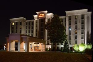 a hotel building at night with a neon sign on it at Hampton Inn & Suites by Hilton Windsor in Windsor