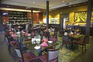 a restaurant with tables and chairs and a bar at DoubleTree by Hilton Napa Valley - American Canyon in American Canyon