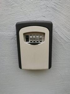 a lightswitch on a white wall at Studio avec grande terrasse in Saint-Denis