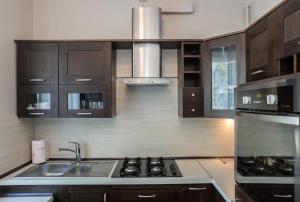 a kitchen with a sink and a stove top oven at Apartament Abrahama in Gdynia