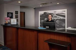 a man sitting at a bar with a laptop at Hampton Inn Youngstown West in Mineral Ridge