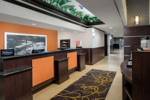 a hotel lobby with a waiting area with orange walls at Hampton Inn & Suites Lake City in Lake City