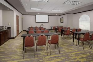 a conference room with tables and chairs and a screen at Hampton Inn & Suites Lake City in Lake City +15 photos