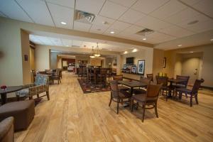 a restaurant with tables and chairs in a room at Hampton Inn Fort Morgan in Fort Morgan