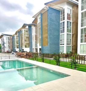 a swimming pool in front of a apartment building at CJ’sstaycation in Lapu Lapu in Maribago
