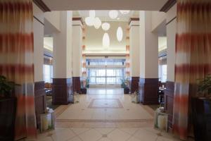 a hallway in a building with columns and a large window at Hilton Garden Inn Albuquerque Uptown in Albuquerque