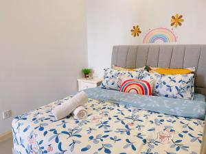 a bedroom with a bed with a blue and white comforter at Legoland 2RB HappyBunny Max8px in Nusajaya