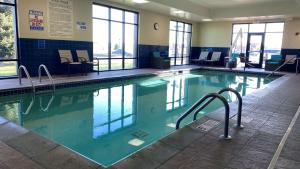 a large swimming pool with blue water in a building at Hampton Inn Minneapolis/Shakopee in Shakopee