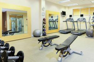 a fitness room with several treadmills and machines at DoubleTree by Hilton Greensboro in Greensboro