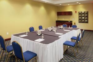 a conference room with a large table and blue chairs at DoubleTree by Hilton Greensboro in Greensboro