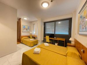 Voodi või voodid majutusasutuse Hotel Dei Fiori toas