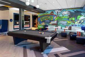 einen Billardtisch in einem Zimmer mit Wandgemälde in der Unterkunft Tru by Hilton Round Rock in Round Rock