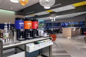 a coffee shop with a counter with bottles on it at Tru by Hilton Round Rock in Round Rock