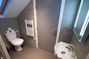 a small bathroom with a toilet and a sink at Comfort on Market St l 1BR 1BA l Gem in Watford in Watford