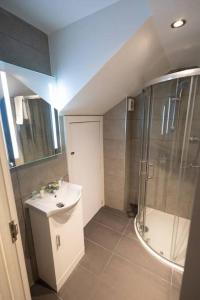 a small bathroom with a sink and a shower at Comfort on Market St l 1BR 1BA l Gem in Watford in Watford