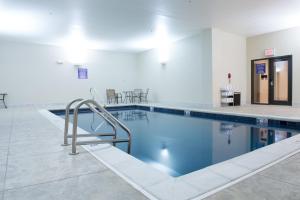 a swimming pool with blue water in a building at Bluemont Hotel in Manhattan