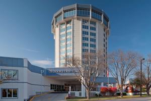 a tall white building with a sign on it at DoubleTree by Hilton Jefferson City in Jefferson City