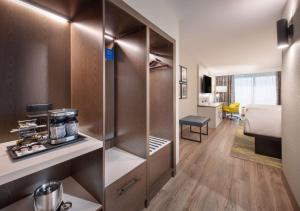 a hotel room with a closet and a bed at DoubleTree by Hilton Monroe Township Cranbury in Rossmoor