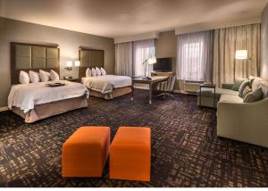 a hotel room with two beds and a couch at Hampton Inn & Suites - Reno West, NV in Reno
