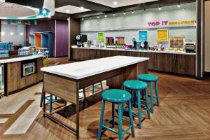 a bar in a store with stools at a counter at Tru By Hilton Terrell in Terrell