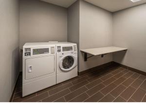 a laundry room with a washing machine and a table at Hampton Inn & Suites - Reno West, NV in Reno +9 photos