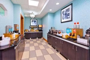 a fast food restaurant with blue walls and counters at Hampton Inn Marysville in Marysville