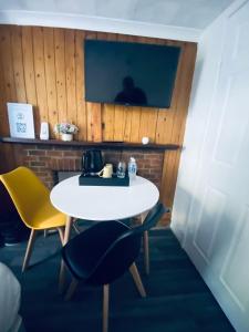 a white table and two chairs in a room at Avalon Hotel in Brighton & Hove